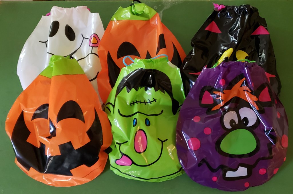 An assortment of Halloween themed drawstring bags filled with candy