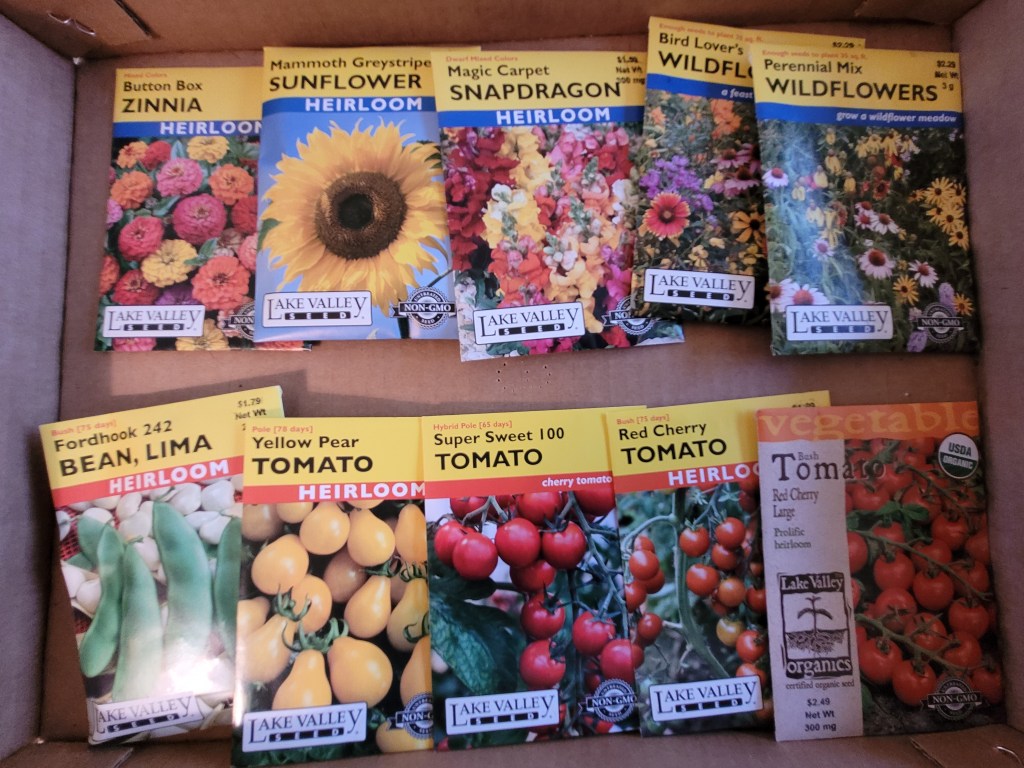 A collection of flower and tomato seed packets