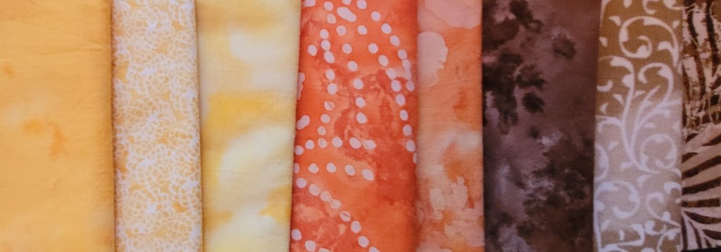 Series of yellow, orange, and tan patterned fabric patches