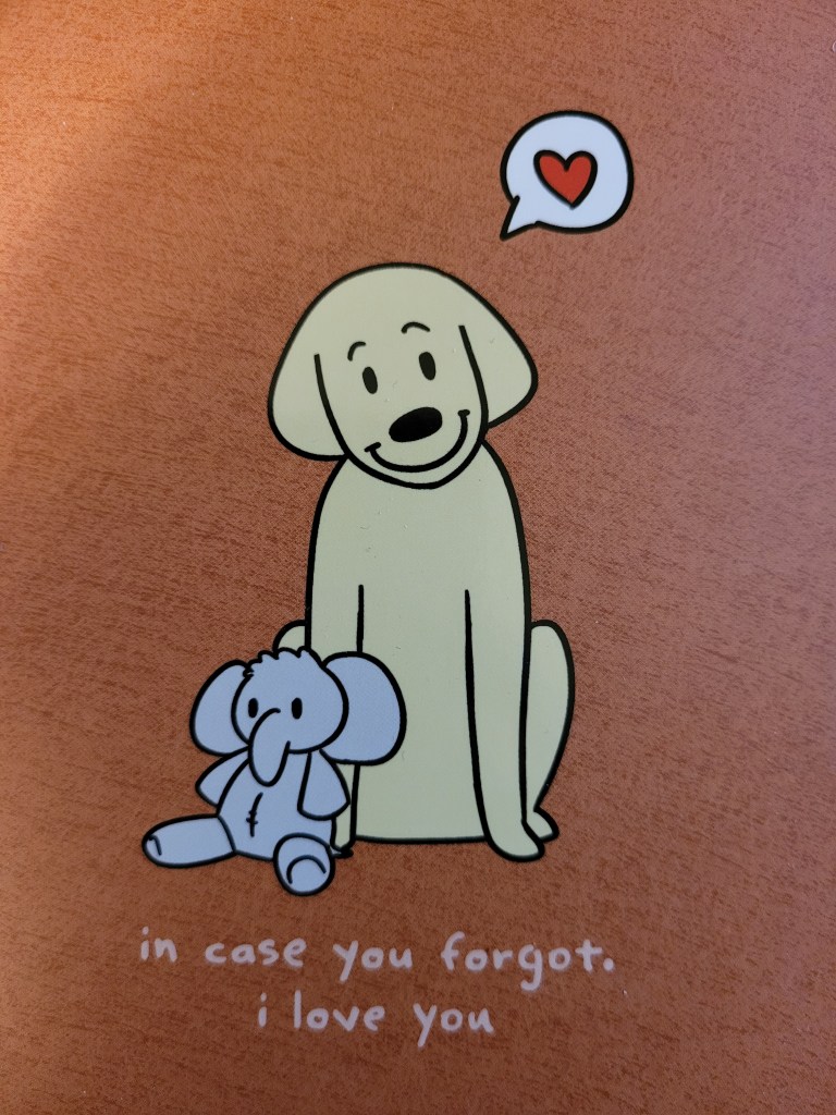 Shot of planner cover with an illustrated dog with a stuffed elephant saying "in case you forgot, i love you"