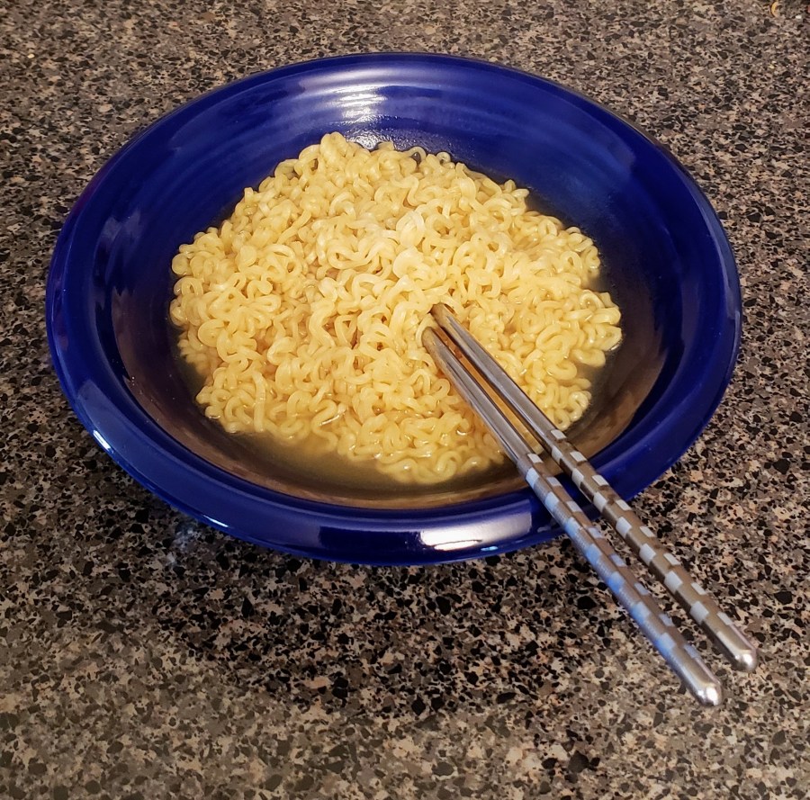 A bowl of ramen with chopsticks