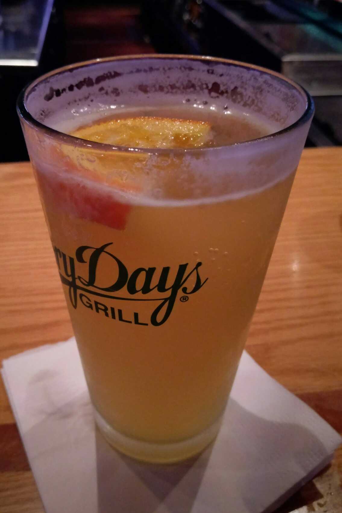 A pint of beer with an orange slice in it