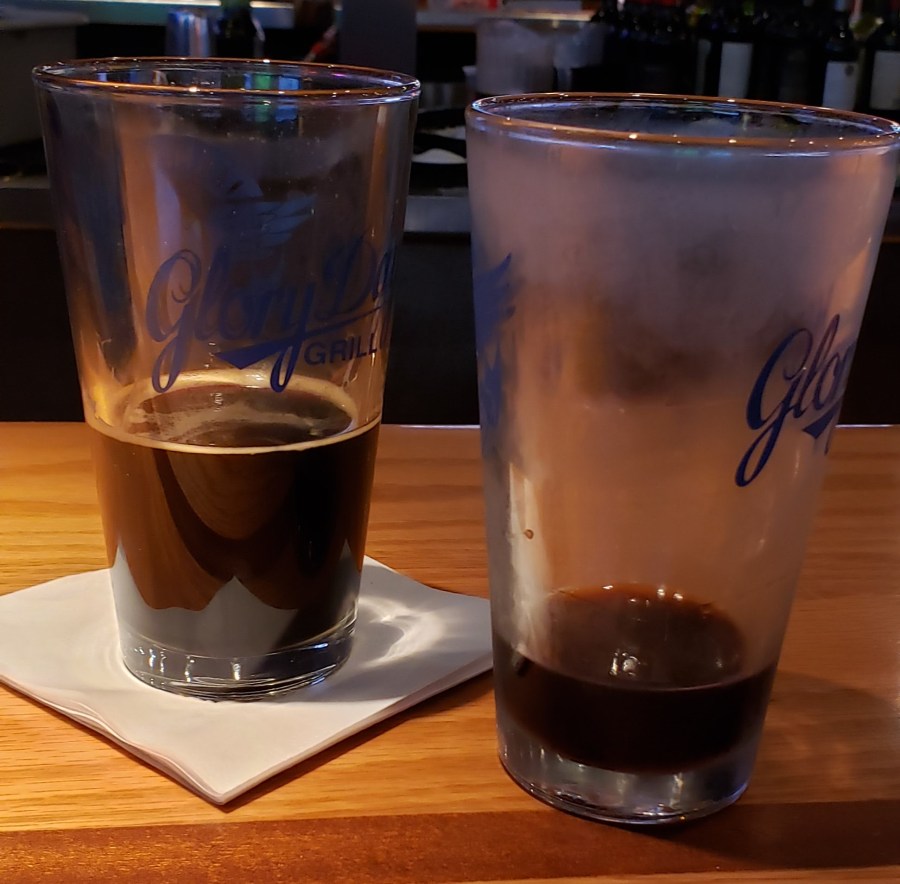 A pint glass with a shot of jager and a half pint of stout