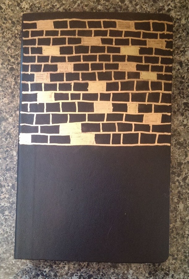 A black notebook with bricks drawn on it from my urban history class