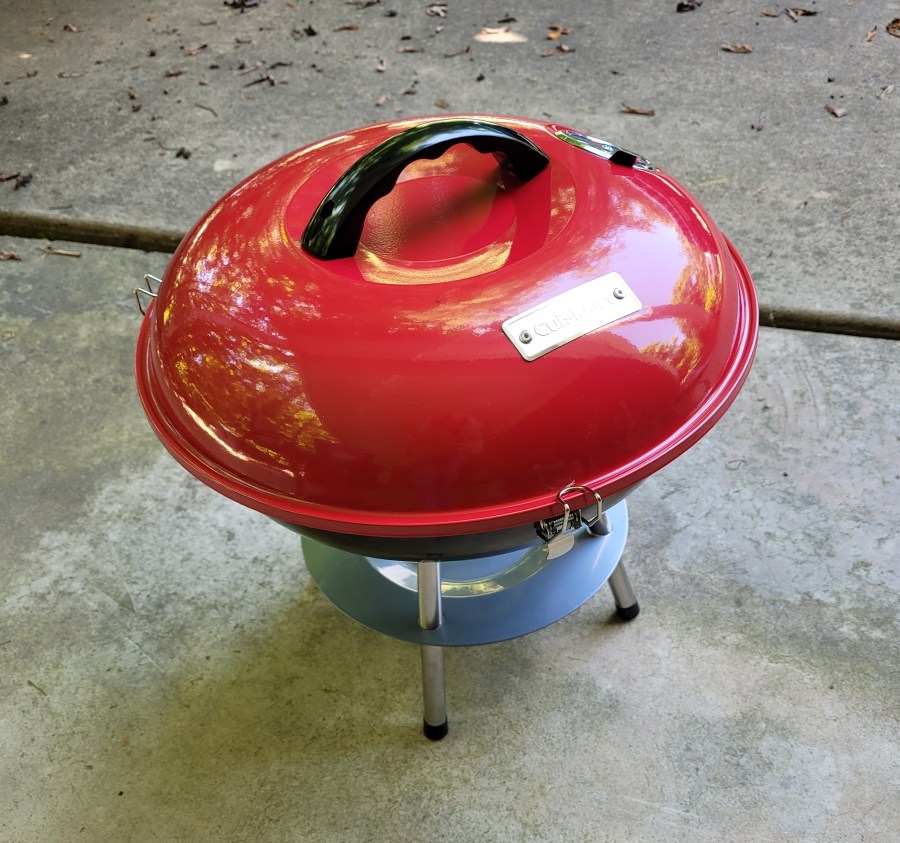 Bright red compact charcoal grill