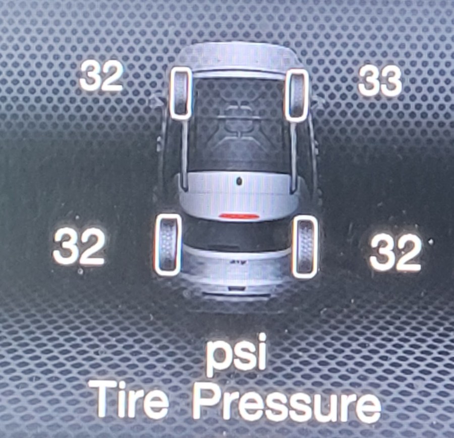 Car dash display showing 3 tires with 32 PSI and one tire with 33 PSI