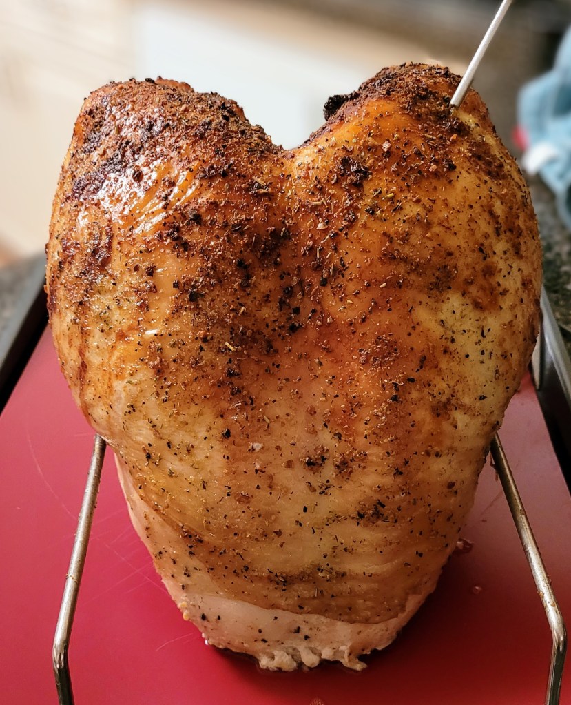 A roasted turkey breast, waiting to be carved