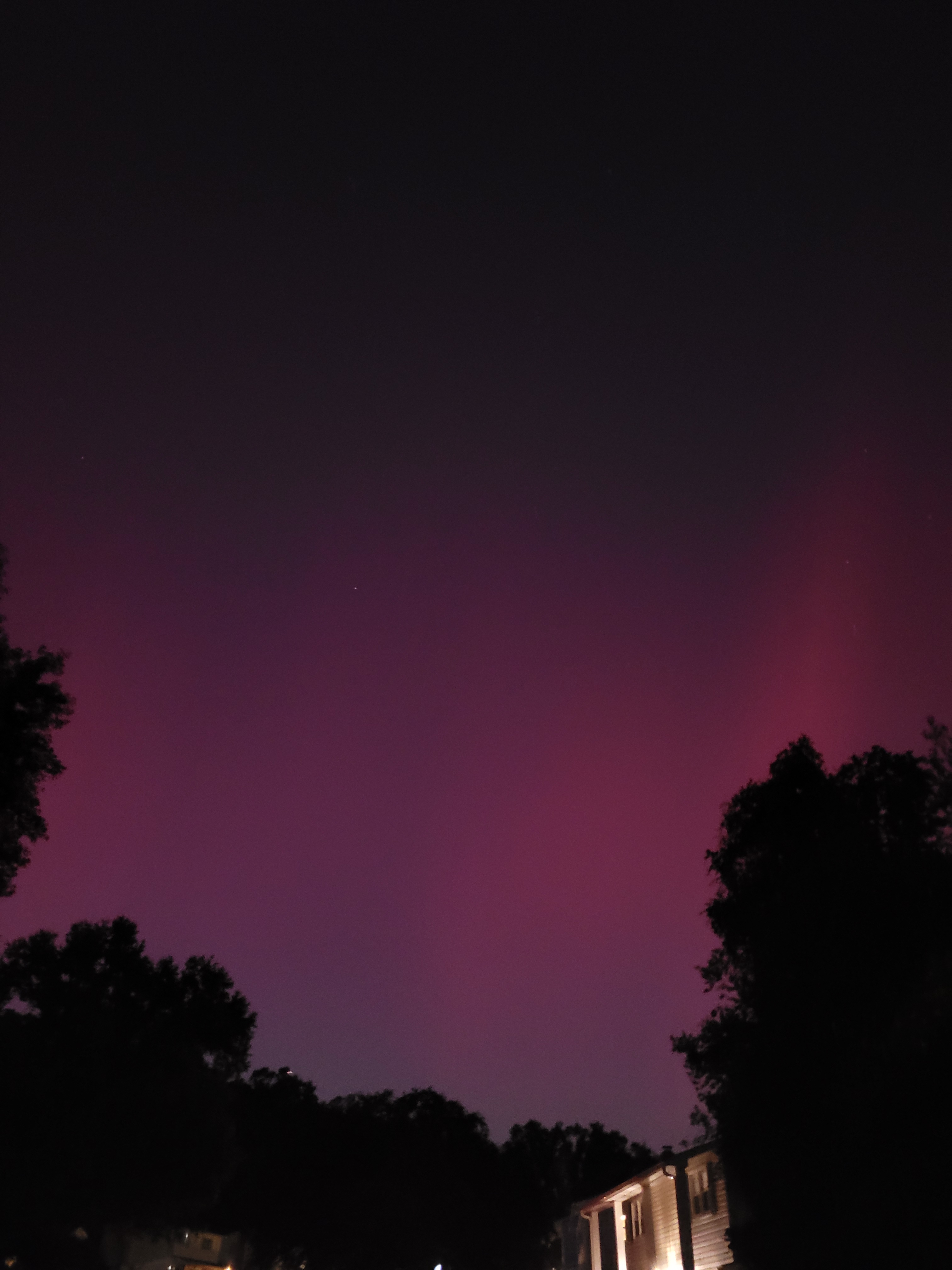Aurora Borealis - the night sky is filled with pink streaks.